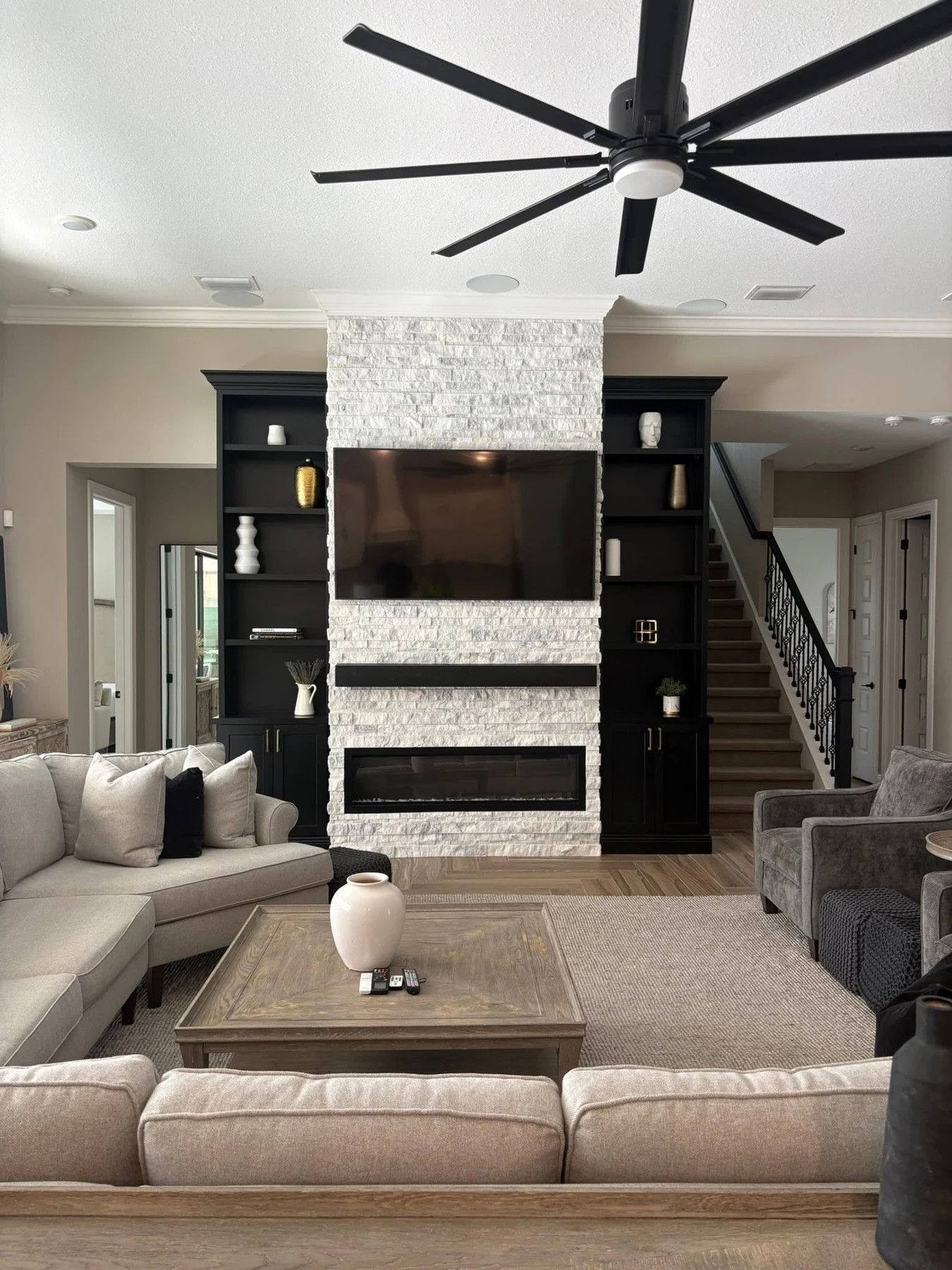 Bright staged living room with a statement fireplace